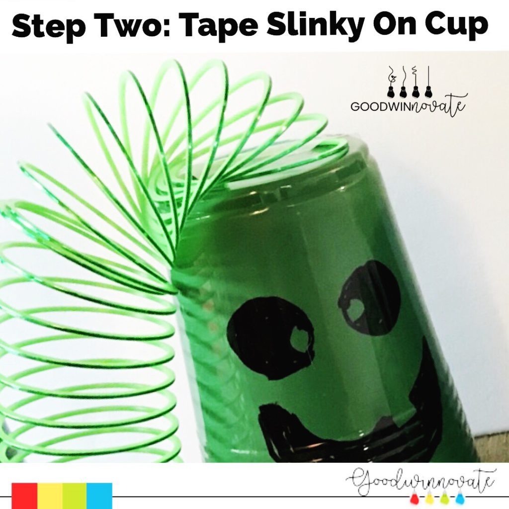 face on green plastic cup with green slinky attached to film on green screen